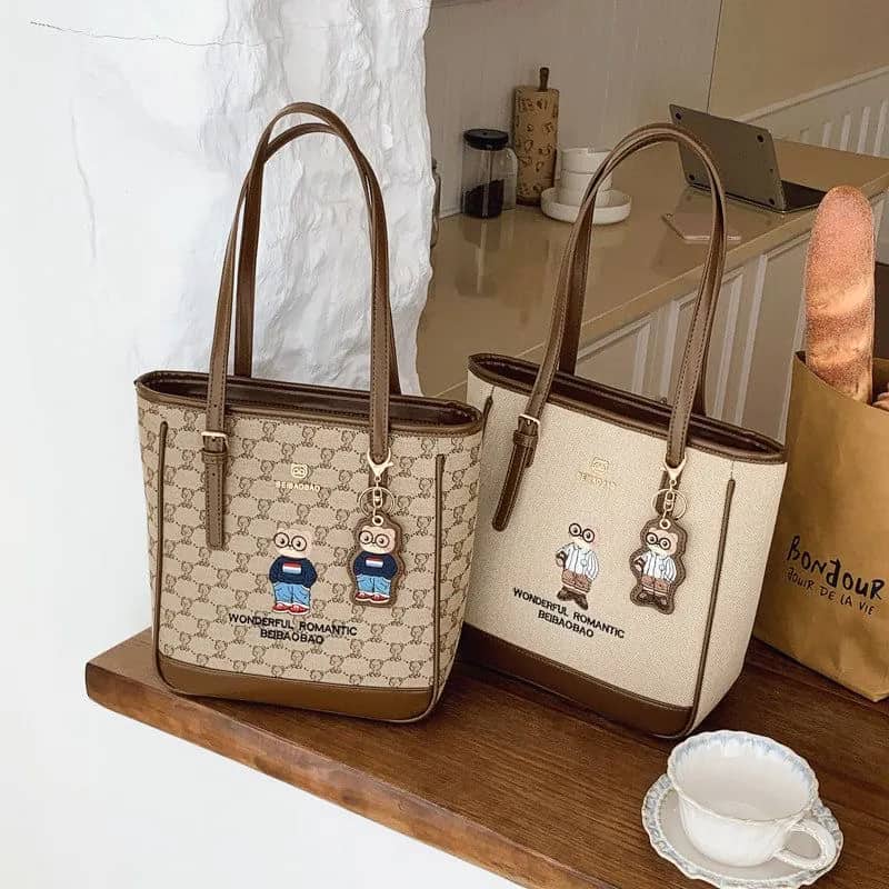 کیف وارداتی تدی گلدوزی جنس کنف بند چرمی قهوه‌ای و کرمی