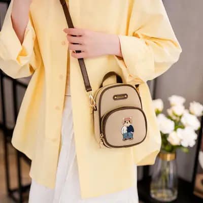 کیف وارداتی تدی دو زیپ جنس کنف بند چرمی قهوه‌ای و کرمی