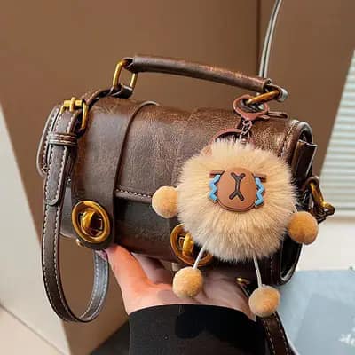 کیف استوانه ای وارداتی مدل رولین رنگ قهوه ای سوخته با دو قفل چرخشی طلایی